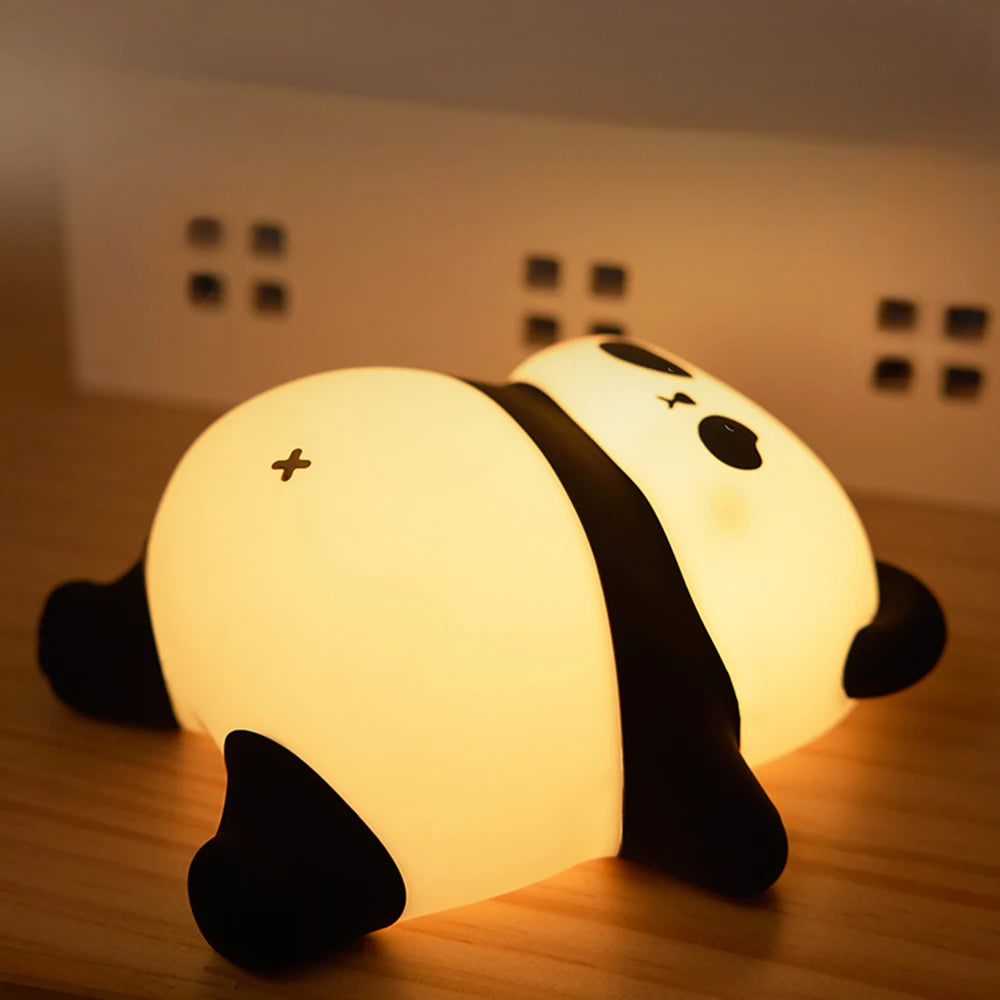 Panda shaped LED night light lamp illuminating a bedroom desk