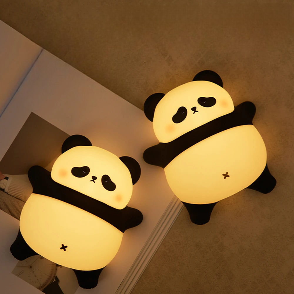 Two Chubby Panda LED Lamps on an open book