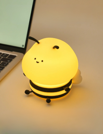 Bumble Bee LED Light glowing on a table next to a laptop