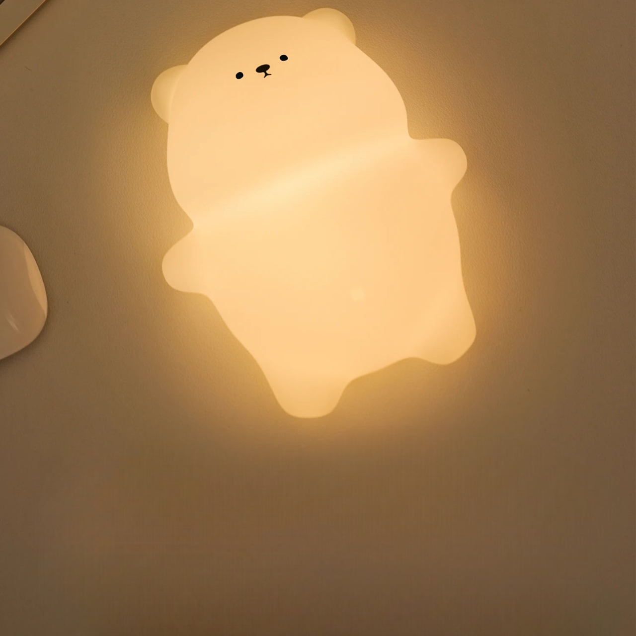Chubby Bear LED Lamp glowing on a counter lying on its back