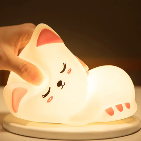 LED Night Light Lamp Kitten laying on table with a hand touching its head