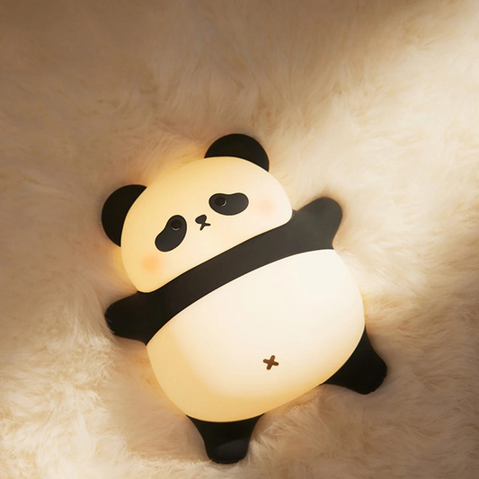 Fat panda LED lamp lying on a soft blanket