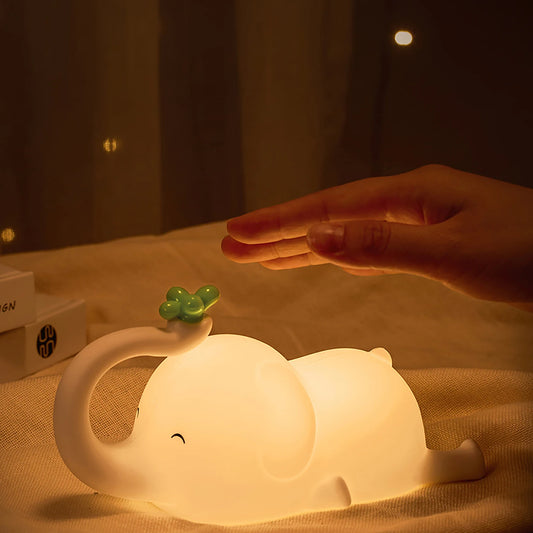 Elephant Shaped LED Lamp Glowing on a Bed