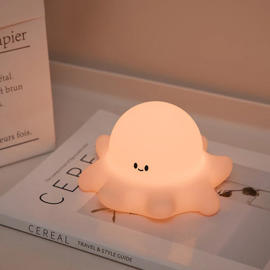 Cute octopus-shaped night light on a book