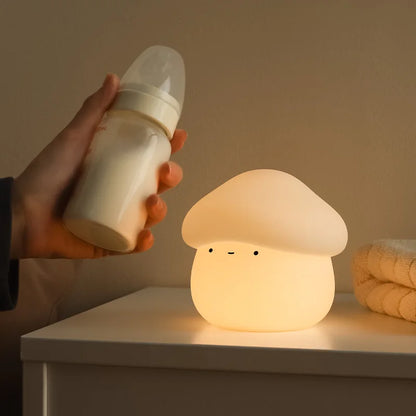 Fantastic Fungi -shaped night light on a surface with a hand holding a bottle nearby.
