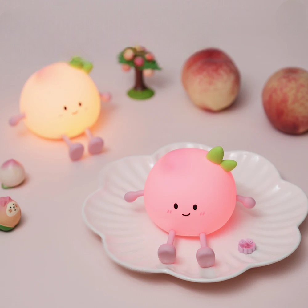 Cute peach-shaped night light with a smiling face on a shell, surrounded by other similar night lights and peaches.