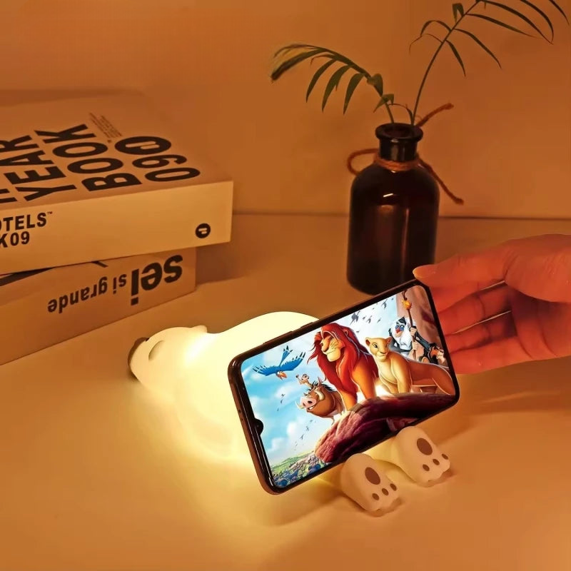 Polar bear LED lamp holding a phone playing the Lion King