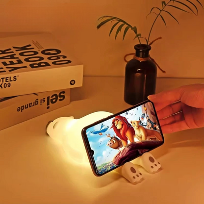 Polar bear LED lamp holding a phone playing the Lion King
