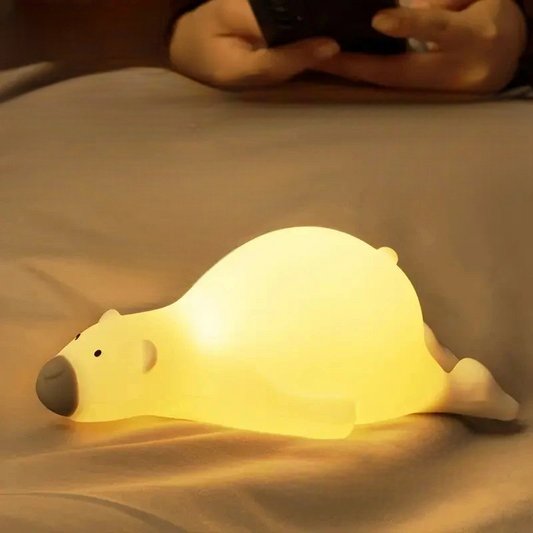 Polar bear led night light lamp lying on a bed illuminating the bedroom