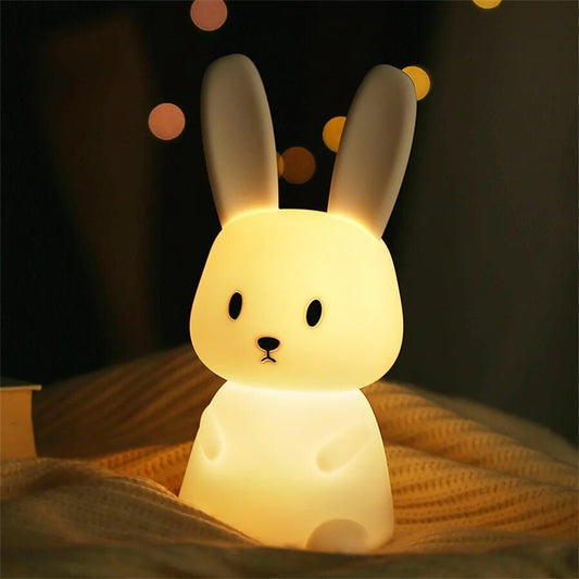 LED Night Light Lamp rabbit sitting on a soft blanket