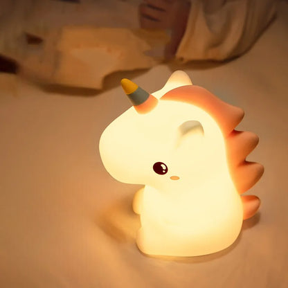 Unicorn LED Lamp next to a child in a bed