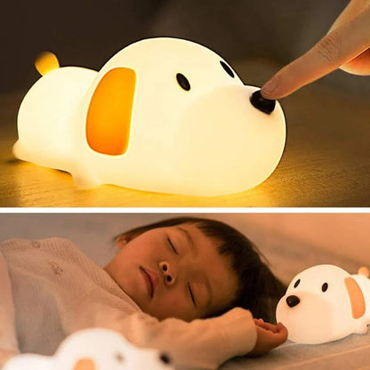 Dog shaped Led Night light lamp laying on a bed with a baby sleeping next to it