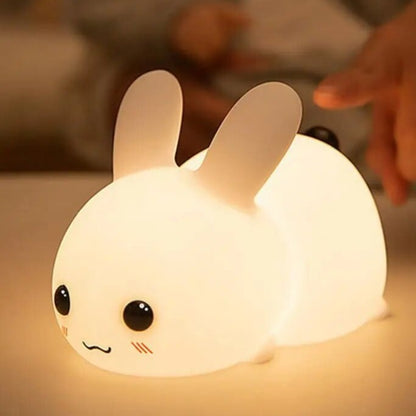 Cute LED Bunny Lamp Glowing on a table beside a bed