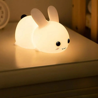 Pudgy Bunny LED Lamp Glowing on a bedside table 