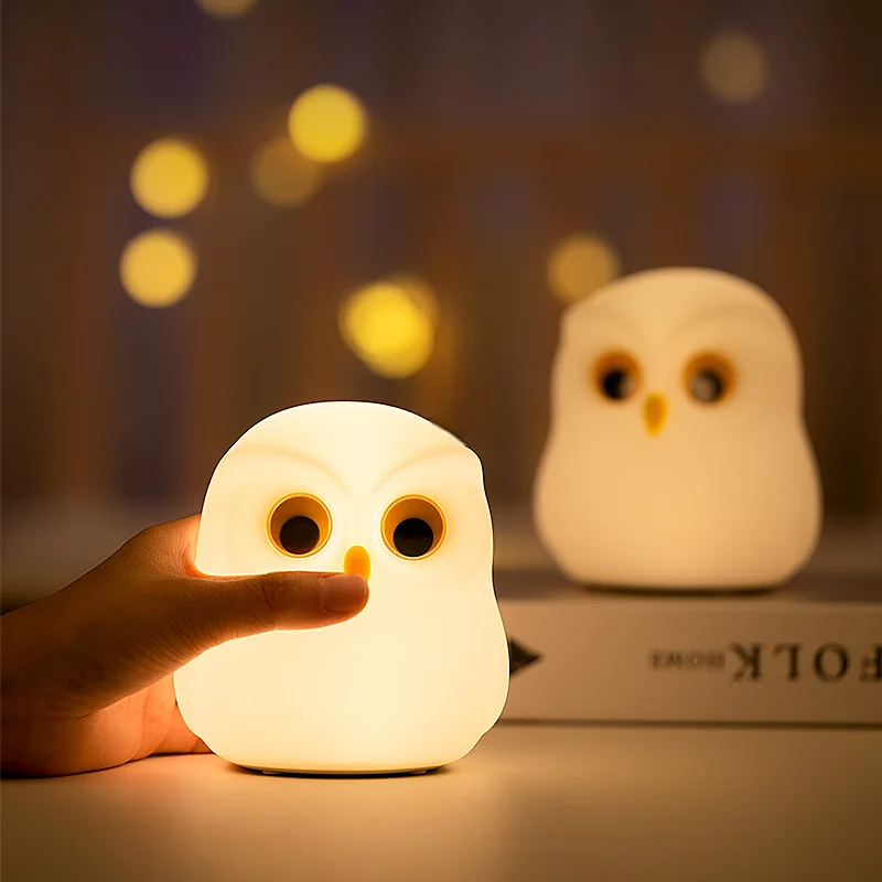 snowy Owl-shaped night light being held with another one in the background by cozzy glow